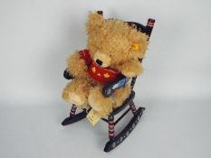 Steiff - a 2007 Steiff teddy bear, displayed in a coloured wooden rocking chair,