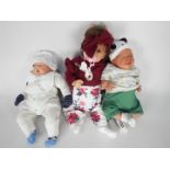 Three reborn / lifelike dolls to include one by Hoomai with open brown eyes, open mouth,