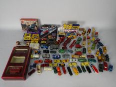 A large collection of over 70 predominately unboxed diecast vehicles in various scales,