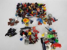 Lego - A case of loose Lego accessories including a quantity of hats, weapons, shields, paddles,