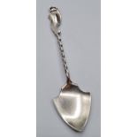 Antique silver spoon in the form of a spade. Having a barley twist handle and scroll work to finial.