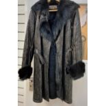 An Yves Saint Laurent fur lined, knee length, leather coat, crafted from Black Metallic Leather (