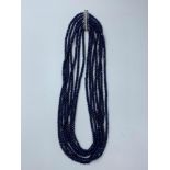 A seven row of faceted. 3-4mm dark blue sapphire beads necklace. Length 44-59cm. Weight 92g