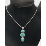 Silver Stone Set Pendant Having Three Turquoise Stones of Square, Oval and Pear Shape, Articulated