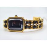 Ladies Chanel dress watch with black face and leather intertwined on strap. Circa 1987