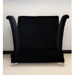 A designer button backed 2 seater sofa in black velvet. Designed by Roche Bobois and measures