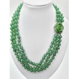A three row green jade necklace with green jade clasp. Length 48-54cm. Total weight: 124g