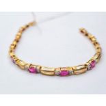 A very pretty 9ct gold bracelet with pink ruby's and diamonds. Weight 6.6g & length 18cms