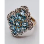 Stone Set Silver Cluster Ring Having Blue Green Topaz Coloured Stones with Silver Beading Border