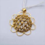 A 21ct far eastern sun pendant. Weight 3.50g and 3cms wide