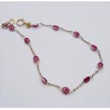 18ct gold bracelet with cabochon ruby's. Weight 1.9g and length 18cms