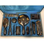 An Antique Ladies Tortoise shell grooming set in a satin lined vanity case.Very good condition.