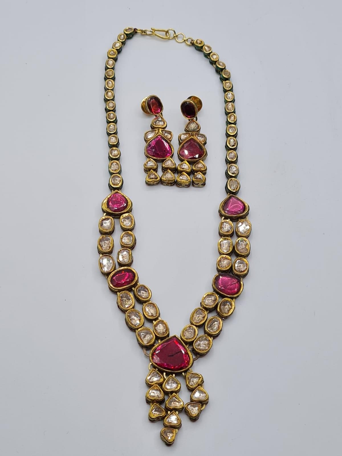 An antique handmade and decorated ruby and diamond necklace 1 cracked stone with matching earrings