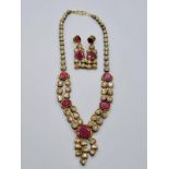 An antique handmade and decorated ruby and diamond necklace 1 cracked stone with matching earrings