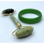 A Chinese green jade bangle in original box and a Chinese jade massage roller. Bangle internal