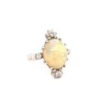 18K white gold ring with 6ct oval opal cabochon centre and 0.36ct diamonds (G/I, SI), weight 6.47g