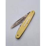 Vintage pen knife with ivory coloured handle and blank cartouche. Twin bladed one large one small.