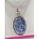 Large stone set silver pendant and chain. Having a blue agate marked in an oval silver setting.