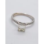 18CT W/G EMERALD CUT DIAMOND WITH DIAMOND SET SHOULDERS 0.91CT J VVS2 ON A WGI CERTIFICATE 2.3G SIZE