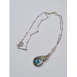 Silver Pendant and Chain. Pendant having clear stones to top and blue topaz coloured oval