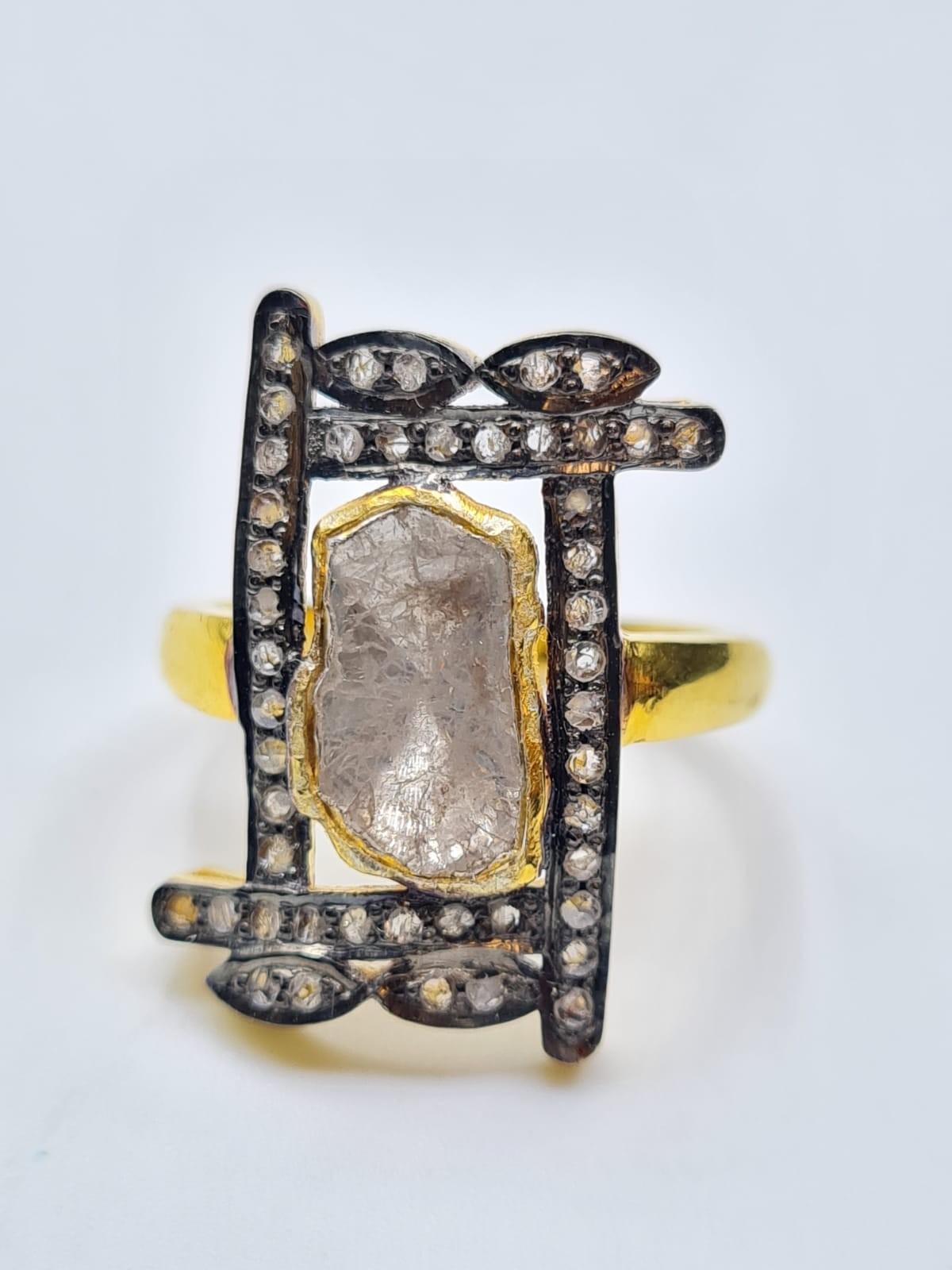 An antique yellow and white metal (untested) ring with a central rough (uncut) natural diamond (