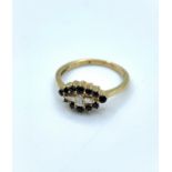 9ct yellow gold ring with 3 diamond centre baguettes surrounded by 12 sapphires, weight 2.1g and