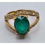 Silver Ring Having Oval Green Stone to Top and Zirconia's Surround on 'V' Shaped Shoulders. Silver