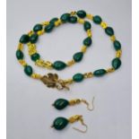 An emerald and 18k gold filled foo dogs necklace and matching earrings set. Necklace length 77cm.