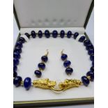 A 'midnight blue', opaque sapphire necklace with matching earrings in presentation box. Clasp, in