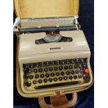 An olivetti 1960s typewriter in portable case. 30x34cms