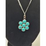Silver pendant and chain. Extra long silver chain with turquoise pendant in the form of a flower.