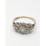 Stone set 9ct Gold Cluster Ring, having a large centre clear stone with a 14 Zirconia surround, size