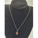 Stone Set silver Pendant and Chain. Having a Heart Shaped Ruby Coloured Stone with Silver Heart