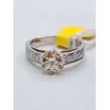 1.01ct diamond set in 14ct gold with 0.50ct diamond shoulders, weight 4.3g and size M