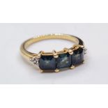 9ct Gold Ring having a three setting to mount. Stones are square form and test as tanzanite, Full UK