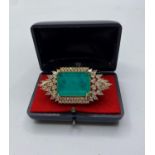 A dress ring with simulated emerald (25x18mm) and sapphires marked 18KGL, designed and signed by "