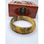 A quality carved jade bracelet in wooden presentation box. Weight of bracelet: 48g.