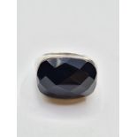 Stone set silver ring having a large faceted black rectangular stone set on a smooth silver shank.