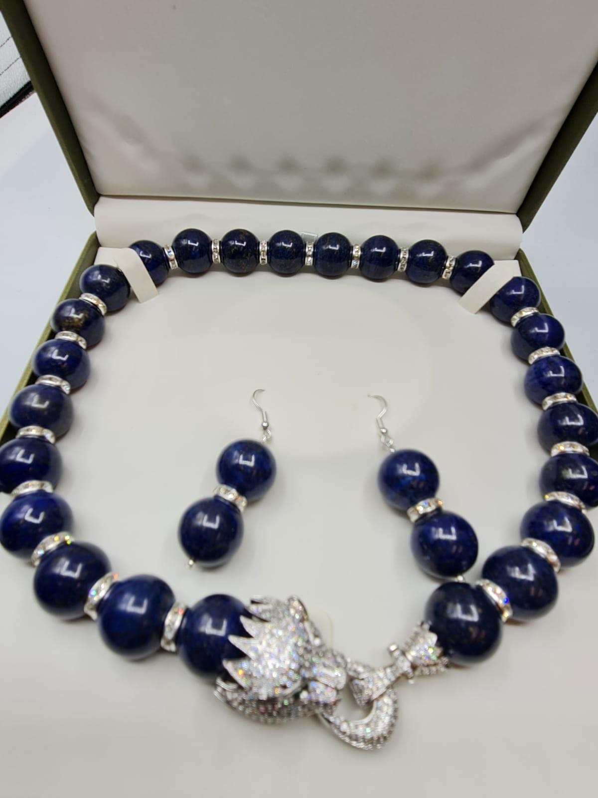 A large beaded lapis lazuli necklace and earrings set in presentation box.The white metal (untested)