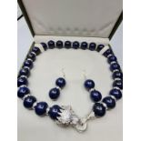 A large beaded lapis lazuli necklace and earrings set in presentation box.The white metal (untested)
