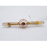 Edwardian 9ct gold bar brooch with seed pearls and centre garnet, weight 2.5g and 5cm long