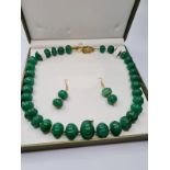 A large beaded, green jade, hand carved necklace and earrings set in a Presentation box. Necklace