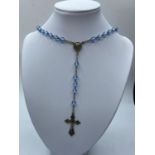 Silver rosary in leather pouch with pale blue clear stones, 26" long ,having silver crucifix and