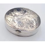 Vintage silver pill box delicate size in oval form. Hinged lid with floral scroll design to top.