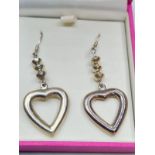 Pair Silver Heart Earrings in drop form. Having three silver shapes above silver hearts, Quality