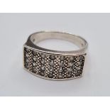 Silver ring having rectangular setting with clear stones and bead work to top. 925 silver marking,