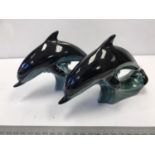 Pair of Poole Pottery dolphins with poole markings to base. 17cm approx each dolphin