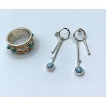 A sterling silver ring with turquoise gemstones and matching dangler earrings