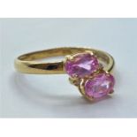 9ct gold pink topaz and diamond RING. having twin faceted oval pink topaz to mount with two small