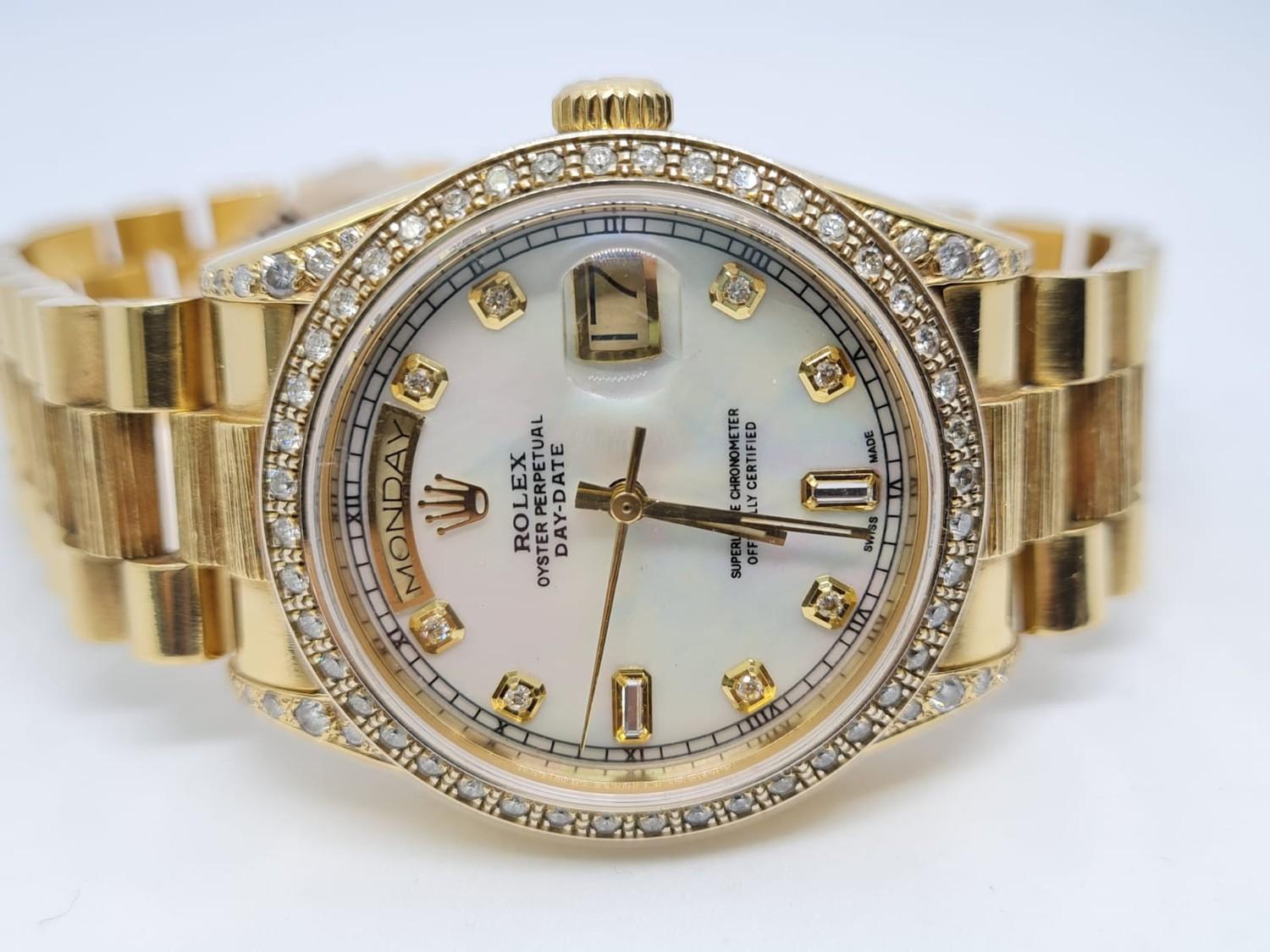 18ct Rolex Day-Date 36mm Costumed Diamond Shoulders and Bezel. 1987 Model. Come with box, no paper.